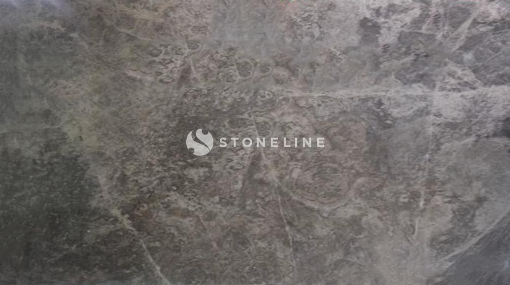 Rough marble surface with visible textures and patterns.