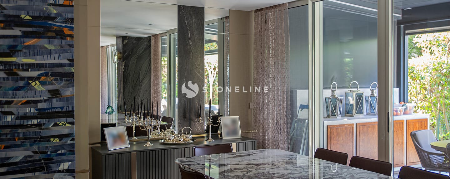 Modern dining room with marble table and decor.