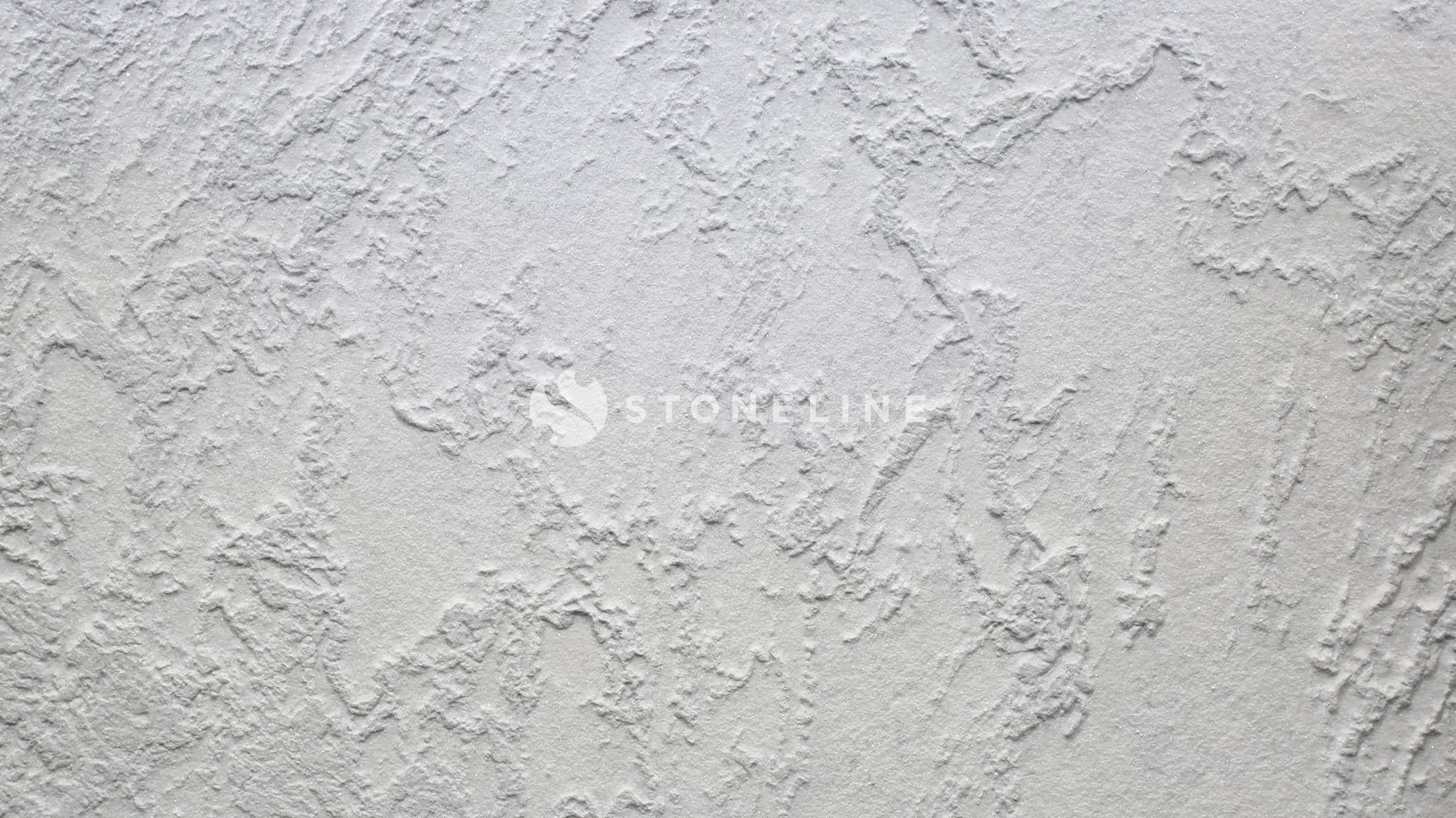 Textured white plaster wall surface close-up