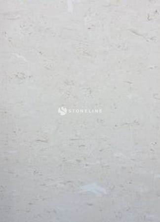 Close-up texture of light-colored stone surface.