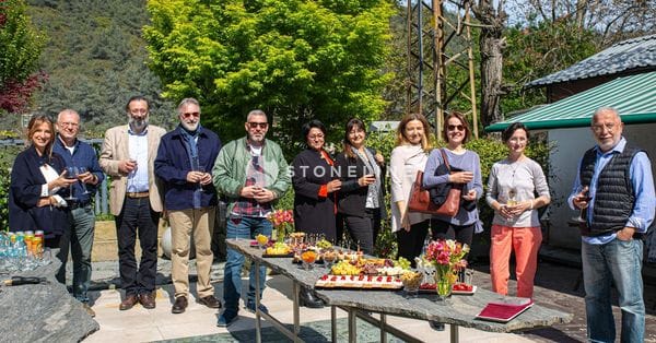 Group enjoying outdoor gathering with food and drinks.