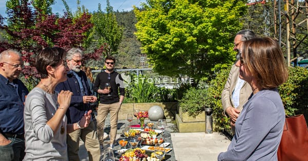 Group enjoying outdoor gathering with food and drinks.