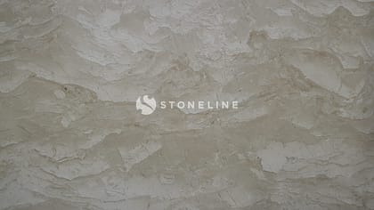 Close-up of textured beige stone surface.
