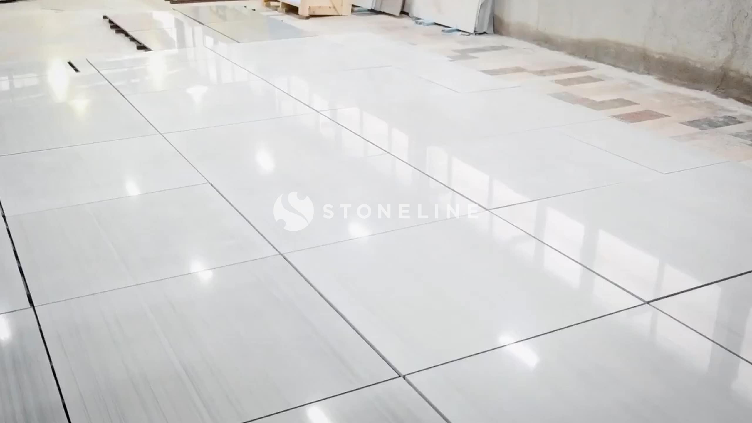 Polished natural stones tiles dry layed in empty room.