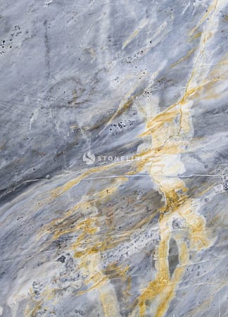 Close-up of textured gray and gold marble surface.