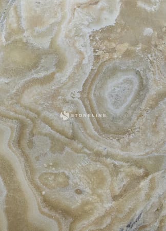 Close-up of beige marble texture with swirls.