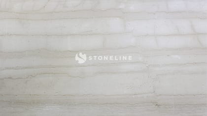 Close-up of beige marble texture with veins.